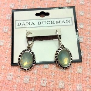 Blue dangle earring with rope design around stone.